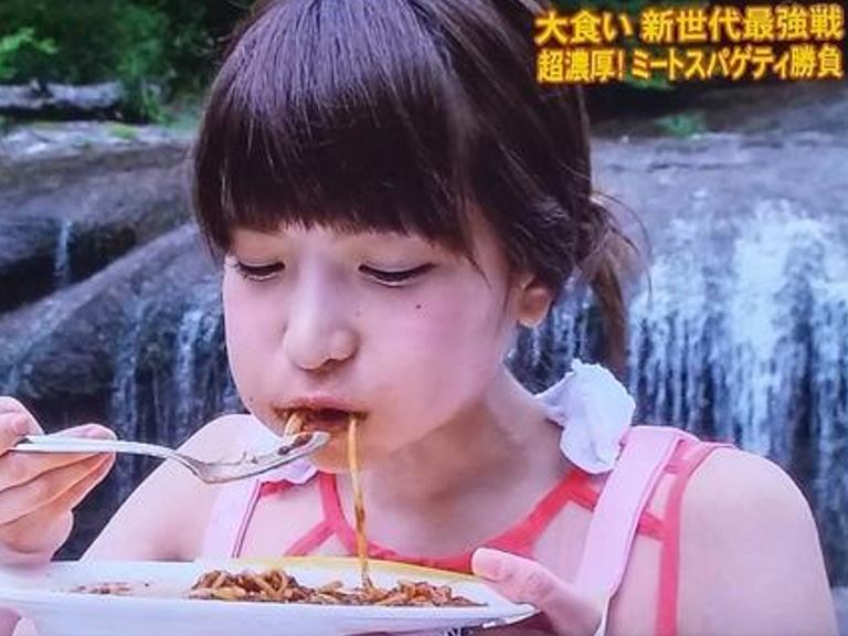 Japanese girl making a face by pulling her mouth, Tokyo, Japan