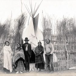 Arapaho family in front of a teepee at 1904 World's Fair